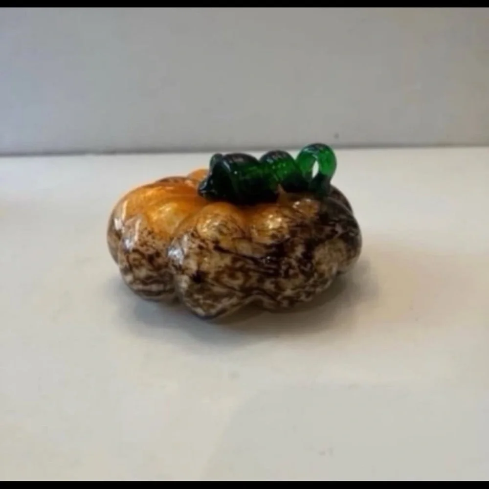 Orange and brown glass pumpkin with green stem